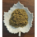 Bedtime Latte hebal blend on a white leaf-shaped dish on a wooden surface