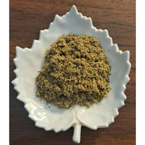 Bedtime Latte hebal blend on a white leaf-shaped dish on a wooden surface