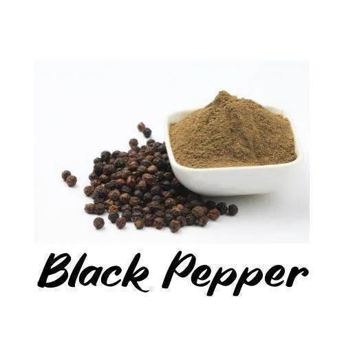 Black pepper with a bowl of ground black pepper on a white background
