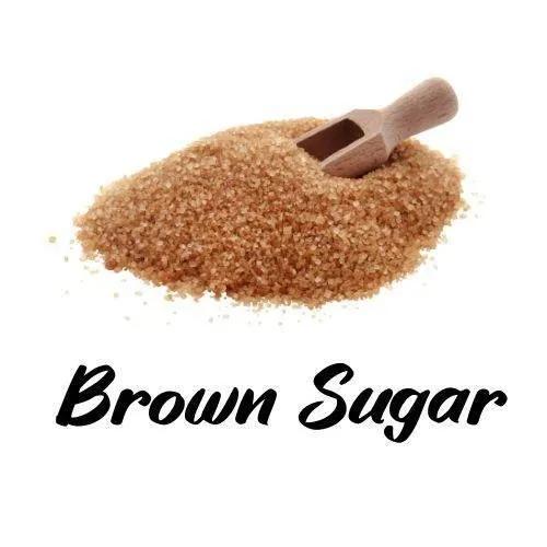 Brown sugar with a wooden scoop on a white background, labeled 'Brown Sugar'.