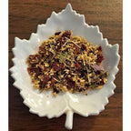 Cold & Flu Relief mix on a white ceramic leaf-shaped dish on a wooden surface