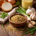 Garlic Onion Bliss Blend in a wooden bowl with onions, garlic, and herbs on a wooden surface