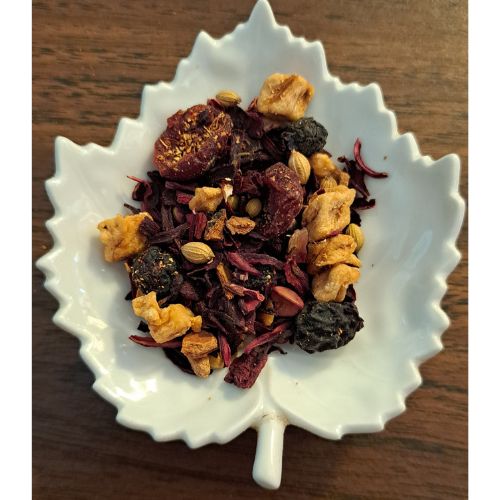 Homestead Fruit Chai fruit blend on a white leaf shaped ceramic dish on a wooden surface