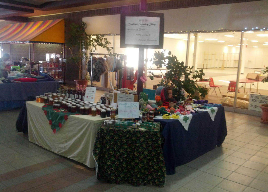 Display with bottles, Jars and Crafts on tables in a mall setting