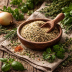 Wooden bowl of ground salt-free spice with a wooden scoop, surrounded by fresh herbs and an onion on a rustic wooden surface.
