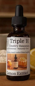 Bottle of Triple H Lemon Extract on a wooden surface with a blurred background