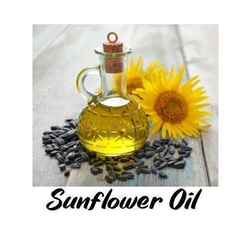 Glass bottle of sunflower oil with sunflower seeds and a sunflower on a wooden surface, labeled 'Sunflower Oil'.